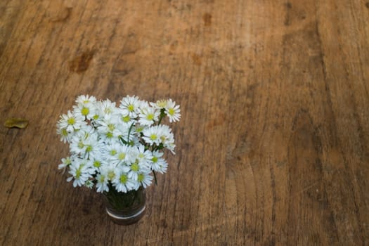 Vintage white flower pot on wooden table, stock photo