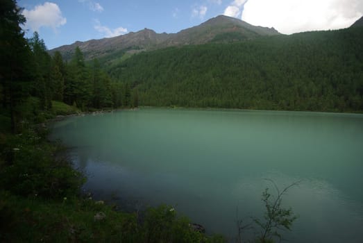 Beautiful mountain landscape near the lake. Mountain Lake. Kind of mountainous terrain and the water in the valley.