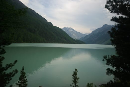 Beautiful mountain landscape near the lake. Mountain Lake. Kind of mountainous terrain and the water in the valley.
