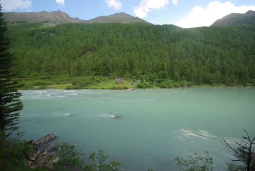 Beautiful mountain landscape near the lake. Mountain Lake. Kind of mountainous terrain and the water in the valley.