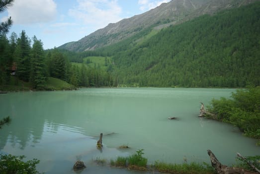 Beautiful mountain landscape near the lake. Mountain Lake. Kind of mountainous terrain and the water in the valley.