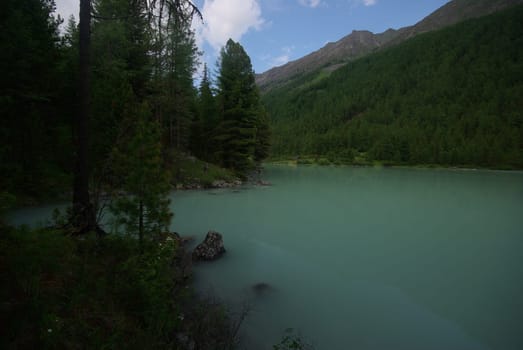Beautiful mountain landscape near the lake. Mountain Lake. Kind of mountainous terrain and the water in the valley.