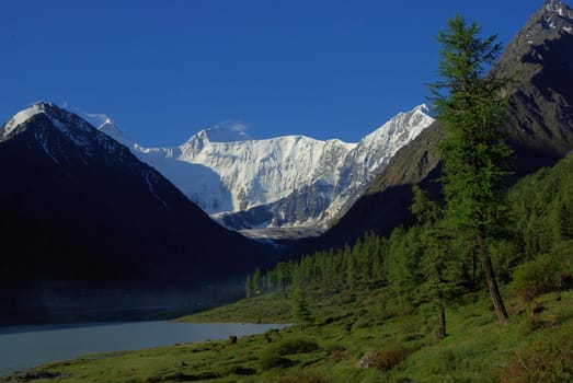 Beautiful mountain landscape near the lake. Mountain Lake. Kind of mountainous terrain and the water in the valley.