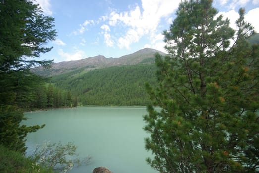 Beautiful mountain landscape near the lake. Mountain Lake. Kind of mountainous terrain and the water in the valley.