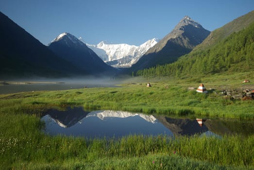 Beautiful mountain landscape near the lake. Mountain Lake. Kind of mountainous terrain and the water in the valley.