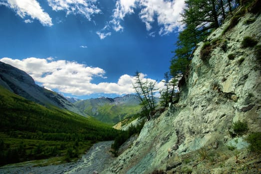 Mountain landscape. Highlands, the mountain peaks, gorges and valleys. The stones on the slopes.