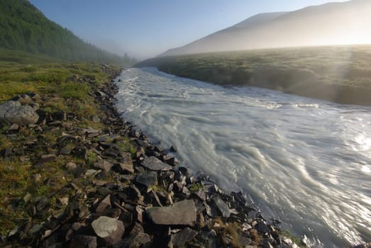 Beautiful mountain landscape near the lake. Mountain Lake. Kind of mountainous terrain and the water in the valley.