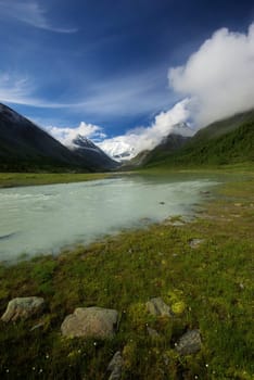 Mountain landscape. Highlands, the mountain peaks, gorges and valleys. The stones on the slopes.