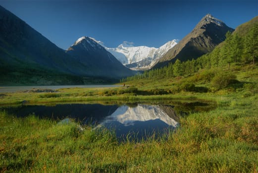 Beautiful mountain landscape near the lake. Mountain Lake. Kind of mountainous terrain and the water in the valley.