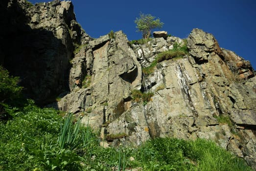 Mountain landscape. Highlands, the mountain peaks, gorges and valleys. The stones on the slopes.