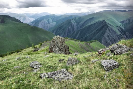 Mountain landscape. Highlands, the mountain peaks, gorges and valleys. The stones on the slopes.