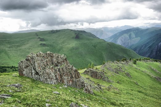 Mountain landscape. Highlands, the mountain peaks, gorges and valleys. The stones on the slopes.