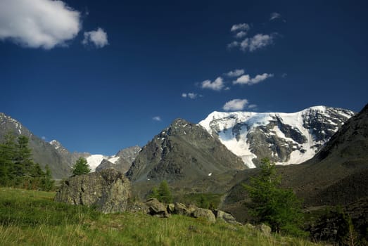 Mountain landscape. Highlands, the mountain peaks, gorges and valleys. The stones on the slopes.