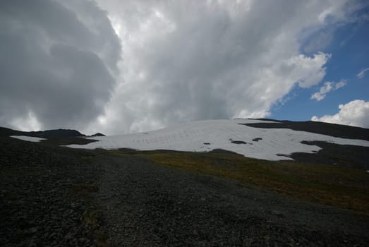 Mountain landscape. Highlands, the mountain peaks, gorges and valleys. The stones on the slopes.