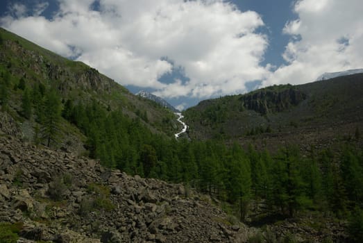 Mountain landscape. Highlands, the mountain peaks, gorges and valleys. The stones on the slopes.