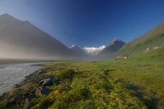 Beautiful mountain landscape near the lake. Mountain Lake. Kind of mountainous terrain and the water in the valley.