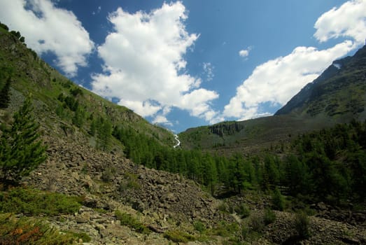 Mountain landscape. Highlands, the mountain peaks, gorges and valleys. The stones on the slopes.