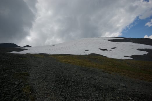 Mountain landscape. Highlands, the mountain peaks, gorges and valleys. The stones on the slopes.