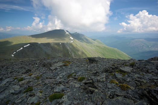Mountain landscape. Highlands, the mountain peaks, gorges and valleys. The stones on the slopes.