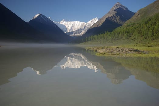 Beautiful mountain landscape near the lake. Mountain Lake. Kind of mountainous terrain and the water in the valley.