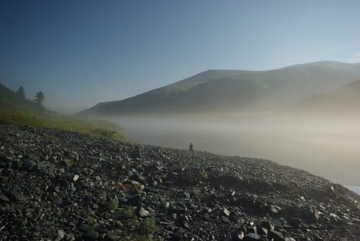 Beautiful mountain landscape near the lake. Mountain Lake. Kind of mountainous terrain and the water in the valley.