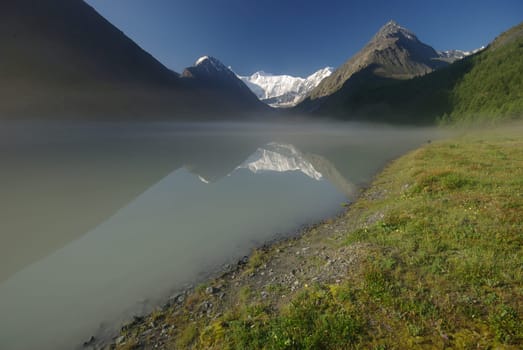 Beautiful mountain landscape near the lake. Mountain Lake. Kind of mountainous terrain and the water in the valley.