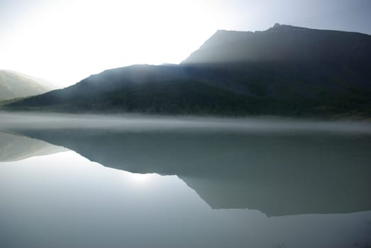 Beautiful mountain landscape near the lake. Mountain Lake. Kind of mountainous terrain and the water in the valley.
