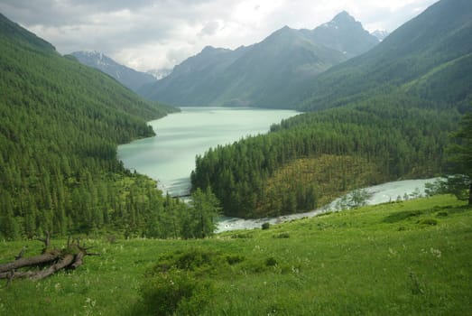 Beautiful mountain landscape near the lake. Mountain Lake. Kind of mountainous terrain and the water in the valley.