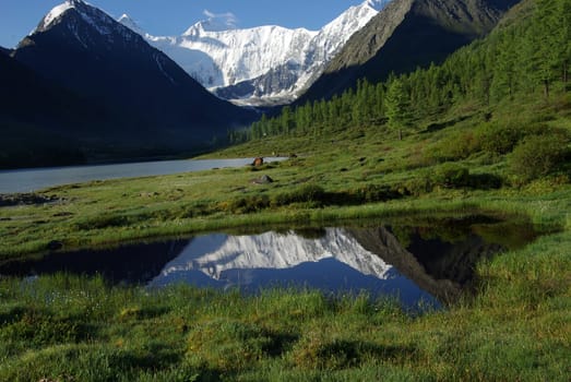 Beautiful mountain landscape near the lake. Mountain Lake. Kind of mountainous terrain and the water in the valley.