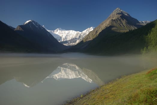 Beautiful mountain landscape near the lake. Mountain Lake. Kind of mountainous terrain and the water in the valley.