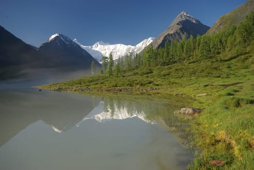 Beautiful mountain landscape near the lake. Mountain Lake. Kind of mountainous terrain and the water in the valley.