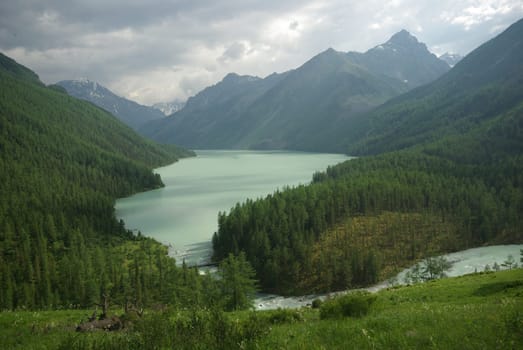 Beautiful mountain landscape near the lake. Mountain Lake. Kind of mountainous terrain and the water in the valley.