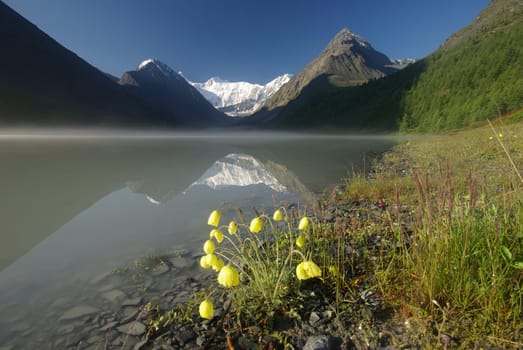 Beautiful mountain landscape near the lake. Mountain Lake. Kind of mountainous terrain and the water in the valley.