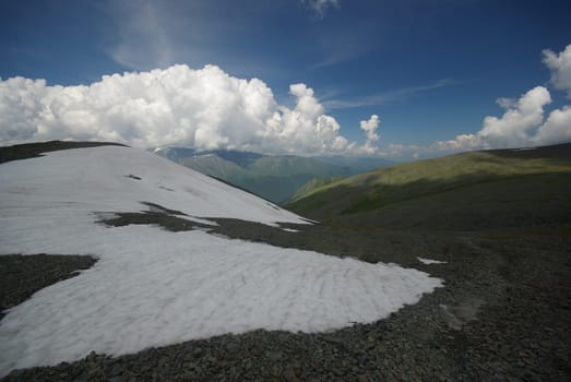 Mountain landscape. Highlands, the mountain peaks, gorges and valleys. The stones on the slopes.