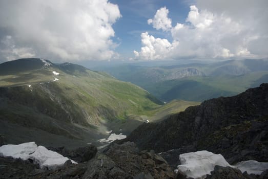 Mountain landscape. Highlands, the mountain peaks, gorges and valleys. The stones on the slopes.