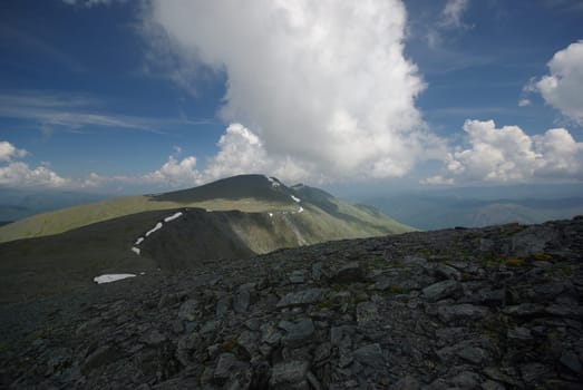 Mountain landscape. Highlands, the mountain peaks, gorges and valleys. The stones on the slopes.