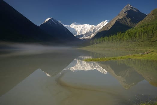 Beautiful mountain landscape near the lake. Mountain Lake. Kind of mountainous terrain and the water in the valley.
