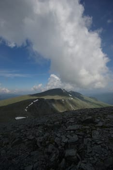 Mountain landscape. Highlands, the mountain peaks, gorges and valleys. The stones on the slopes.