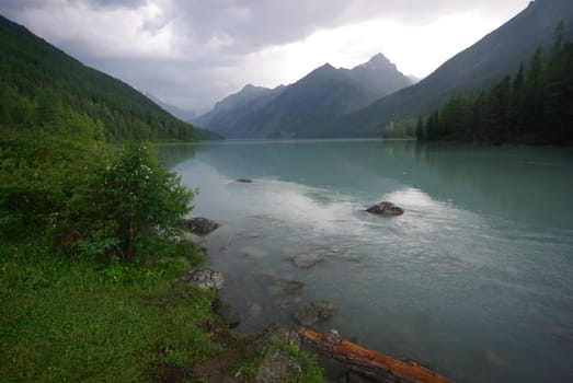 Beautiful mountain landscape near the lake. Mountain Lake. Kind of mountainous terrain and the water in the valley.