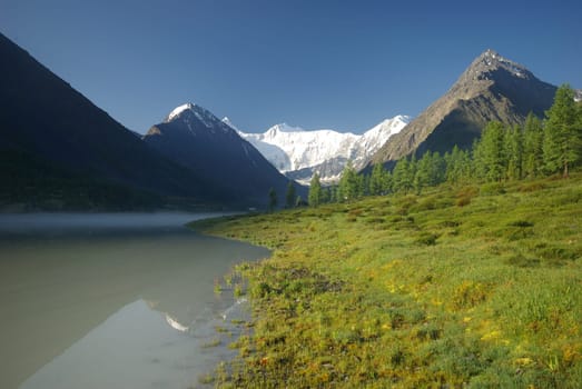Beautiful mountain landscape near the lake. Mountain Lake. Kind of mountainous terrain and the water in the valley.