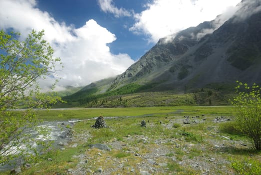 Mountain landscape. Highlands, the mountain peaks, gorges and valleys. The stones on the slopes.