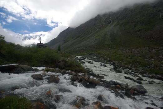 Mountain landscape. Highlands, the mountain peaks, gorges and valleys. The stones on the slopes.