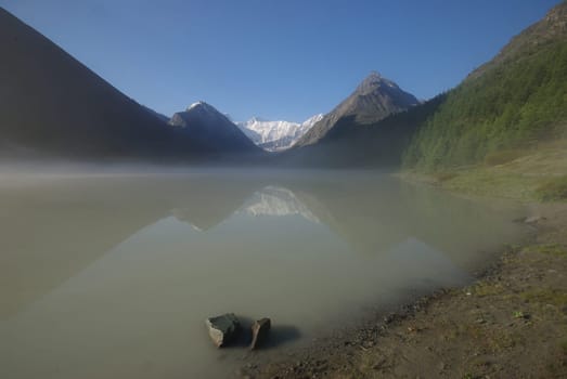 Beautiful mountain landscape near the lake. Mountain Lake. Kind of mountainous terrain and the water in the valley.
