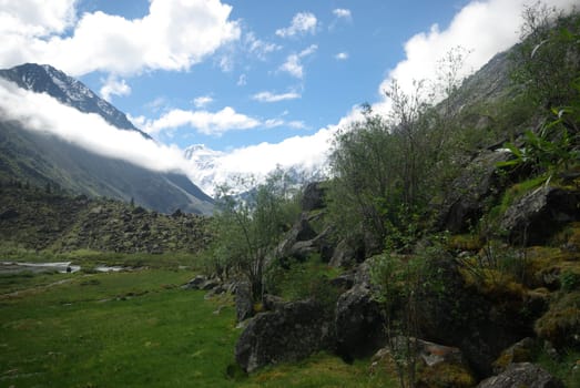 Mountain landscape. Highlands, the mountain peaks, gorges and valleys. The stones on the slopes.