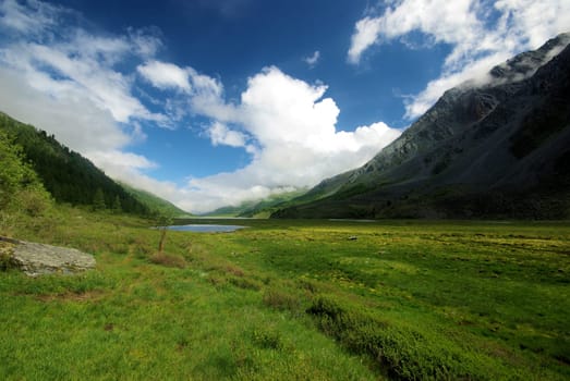 Mountain landscape. Highlands, the mountain peaks, gorges and valleys. The stones on the slopes.