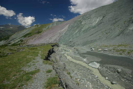 Mountain landscape. Highlands, the mountain peaks, gorges and valleys. The stones on the slopes.