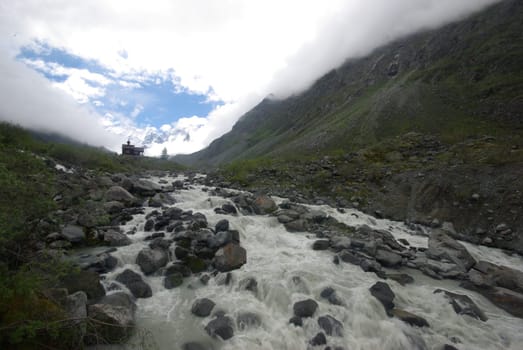 Mountain landscape. Highlands, the mountain peaks, gorges and valleys. The stones on the slopes.