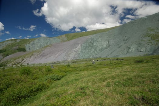 Mountain landscape. Highlands, the mountain peaks, gorges and valleys. The stones on the slopes.