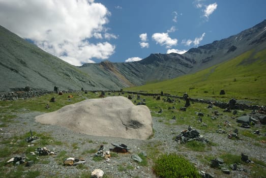 Mountain landscape. Highlands, the mountain peaks, gorges and valleys. The stones on the slopes.