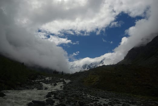 Mountain landscape. Highlands, the mountain peaks, gorges and valleys. The stones on the slopes.